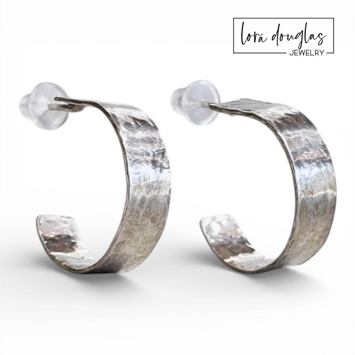 Small silver hoop earrings featuring a textured hammered surface and sterling silver posts, designed for comfortable everyday wear and shoppers searching for versatile minimalist jewelry with subtle detail.