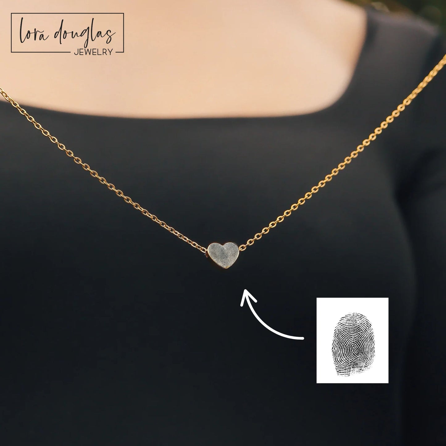 Gold necklace with a heart-shaped pendant on a black background, featuring Lota Douglas Jewelry branding.