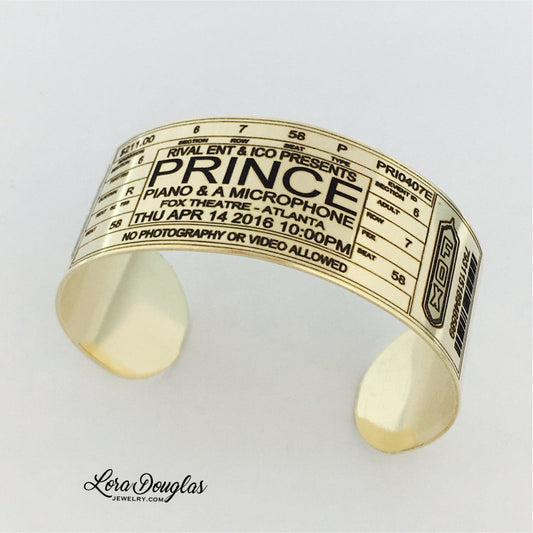 Crafted by Lora Douglas Jewelry, the Special Edition: PERSONALIZED Prince at Fox Theatre Atlanta bracelet is styled as a concert ticket and engraved with details in tribute to Prince’s final show.