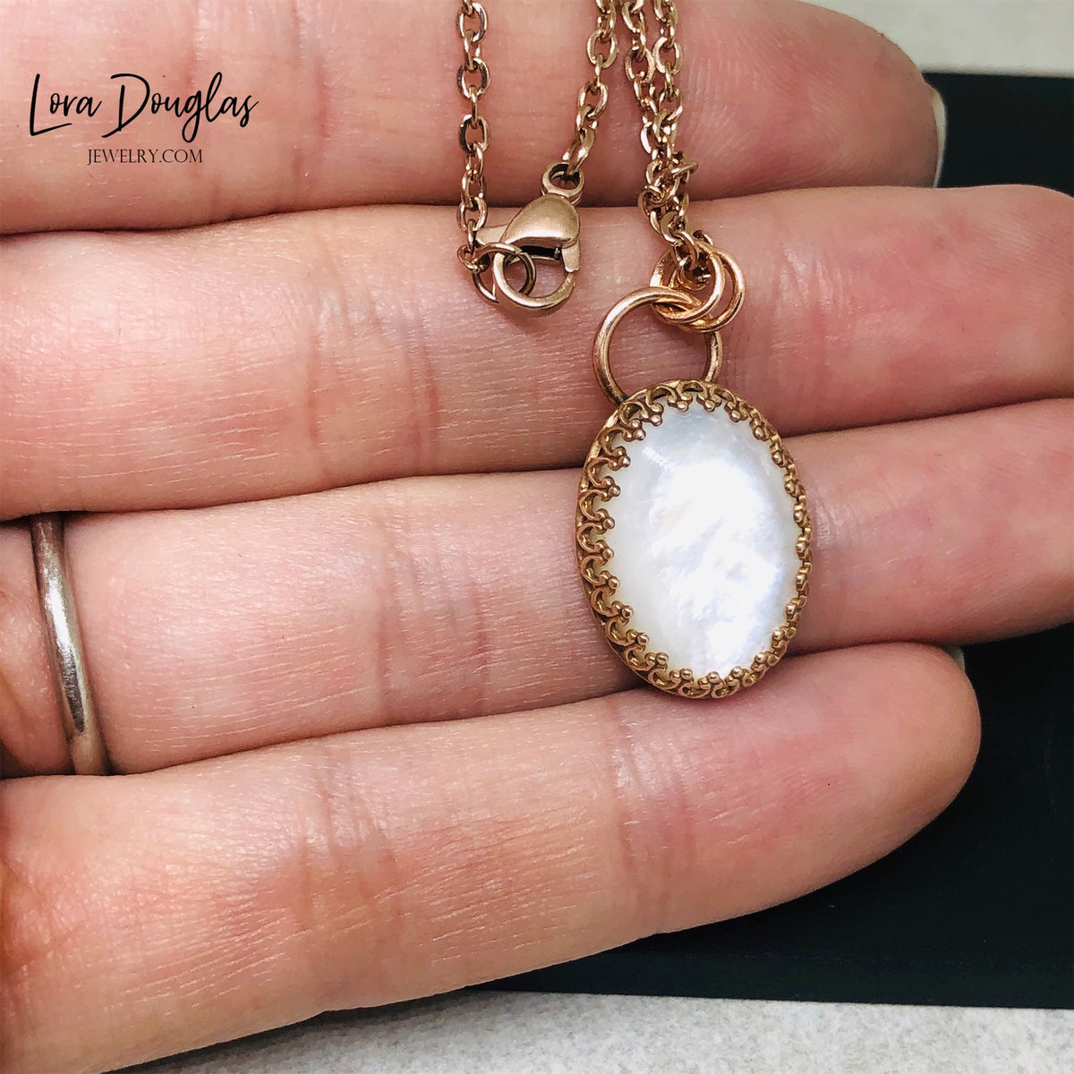 Moonstone gemstone pendant set in warm bronze and paired with a stainless steel necklace chain. This 18 inch natural stone necklace offers a simple mixed metal look for everyday wear or a unique birthday gift for her.