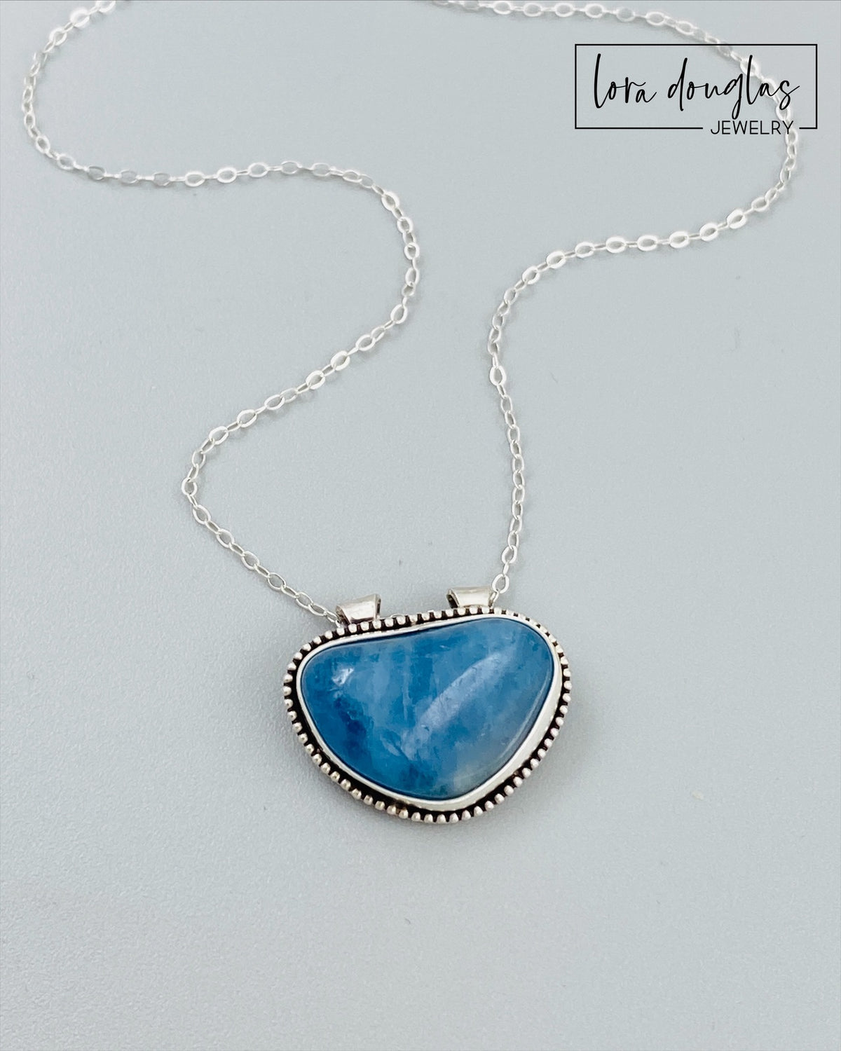 Natural aquamarine pendant necklace with a sterling silver setting and 18 inch antique patina chain, a meaningful jewelry choice for March birthdays, a 19th anniversary or aquamarine lovers.