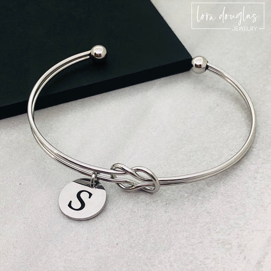 silver stainless steel knot bracelet with initial charm. bridesmaid gift