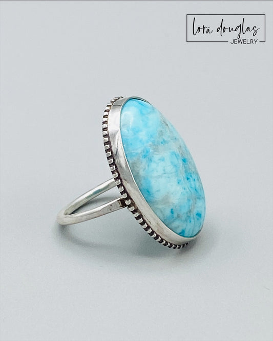 Sterling silver turquoise statement ring featuring a natural 26mm x 19mm gemstone, with the large blue stone as the focal point of this finished size 7 ring for lovers of distinctive turquoise jewelry.