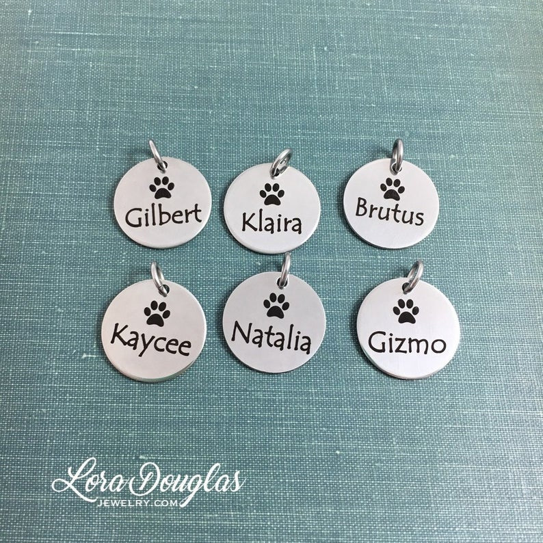 A stainless steel paw print necklace and bangle, with your pet's name engraved on them.