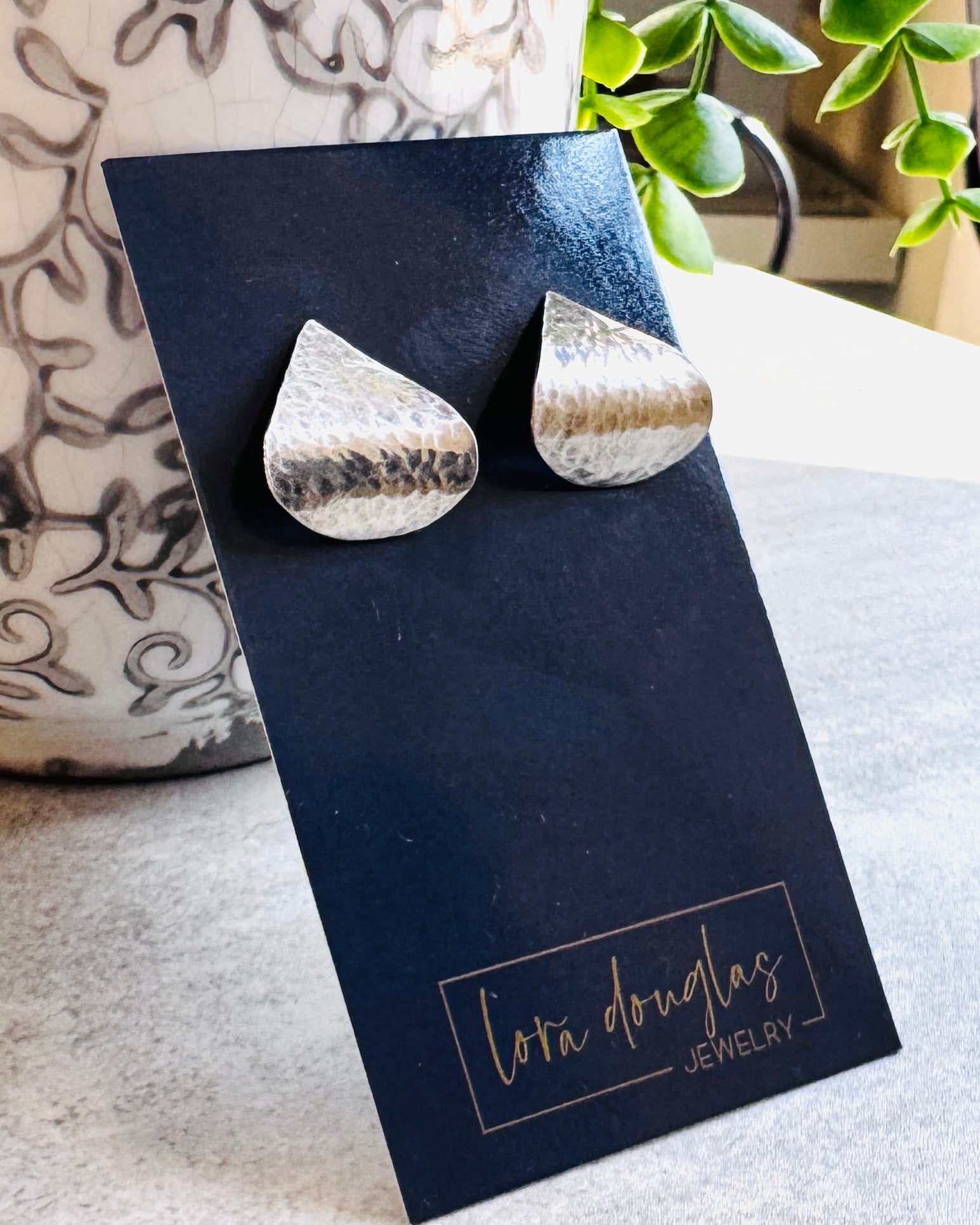 Silver teardrop sterling earrings on a black card with 'Lora Douglas Jewelry' branding.
