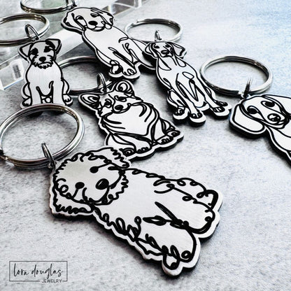 Collection of custom dog breed keychains with multiple dog breed designs for dog lovers.