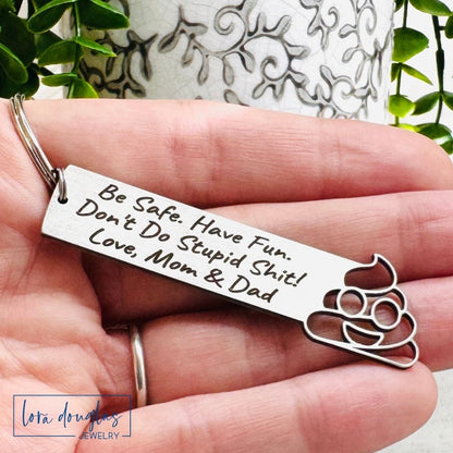 Keychain with engraved message held in a hand, with a decorative background.
Don't Do Stupid Shit Poop Emoji Cutout Keychain, Personalized Funny Stainless Steel Keyring, Customize With Your Name, Gift Bag Included