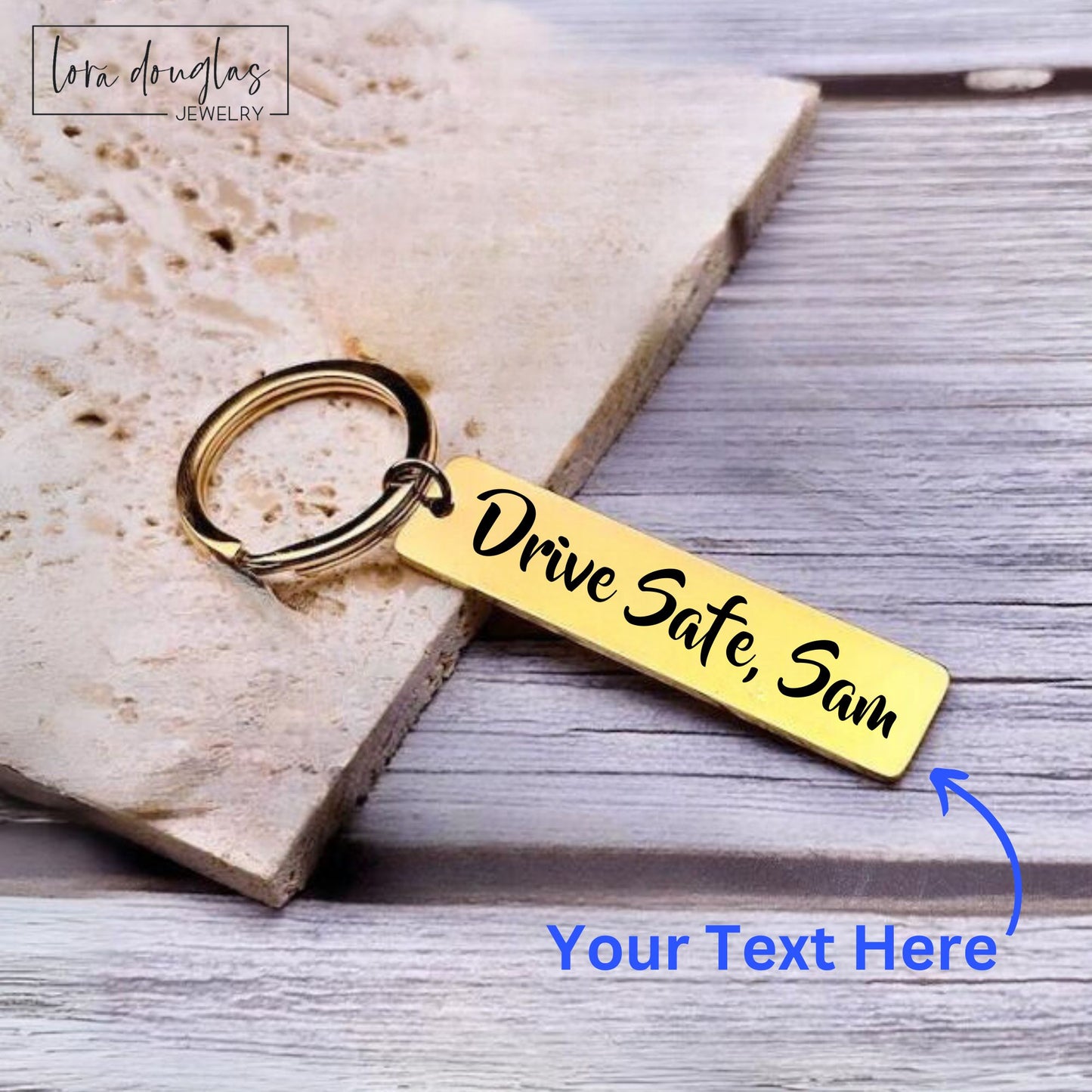 A gold stainless steel keychain with an engraved text