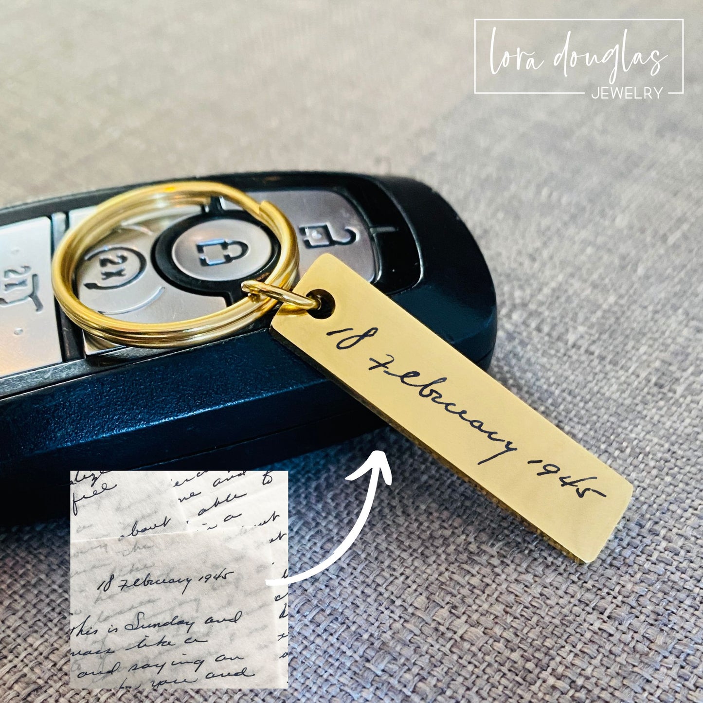 A gold stainless steel keychain with engraved handwriting on a car key.