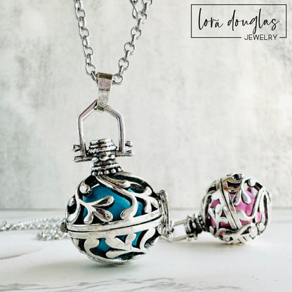 A silver rolo chain necklace with a lobster clasp, featuring a chime pendant with a silver design. The pendant has a textured surface and can be adorned with a Swarovski birthstone charm.