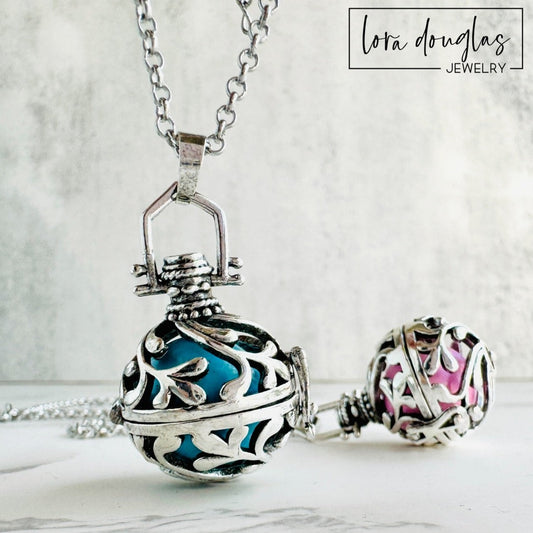 A silver rolo chain necklace with a lobster clasp, featuring a chime pendant with a silver design. The pendant has a textured surface and can be adorned with a Swarovski birthstone charm.