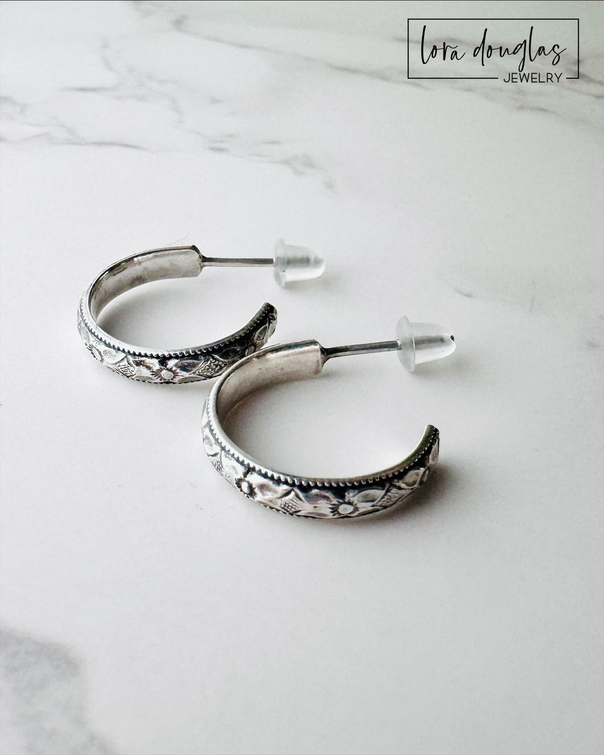 Classic small silver hoop earrings made from 925 sterling silver with post closures, measuring approximately 1/2 inch across for shoppers looking for understated hoops for casual, professional or dressier outfits.
