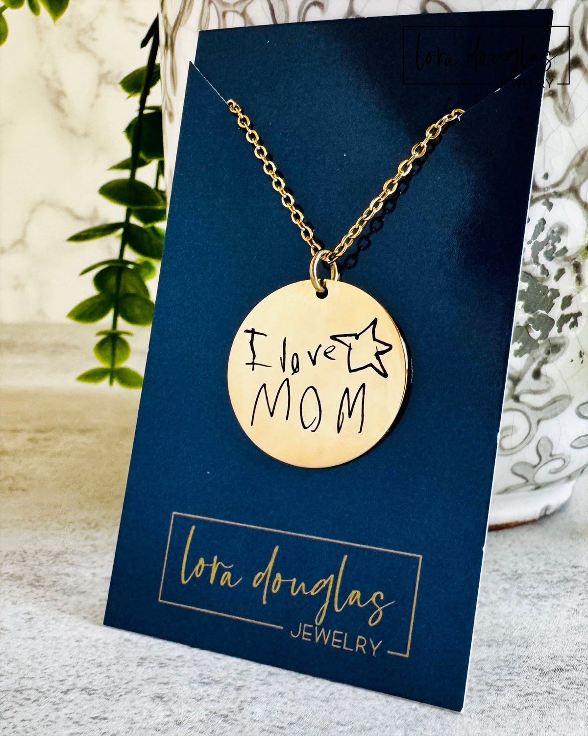 Close view of a custom engraved handwriting pendant available in sterling silver or stainless steel. Personalized jewelry created from a customer's handwritten note with permanent laser engraving that preserves meaningful memories.