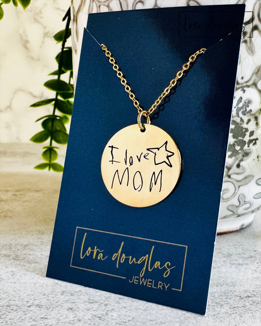 Close view of a custom engraved handwriting pendant available in sterling silver or stainless steel. Personalized jewelry created from a customer's handwritten note with permanent laser engraving that preserves meaningful memories.