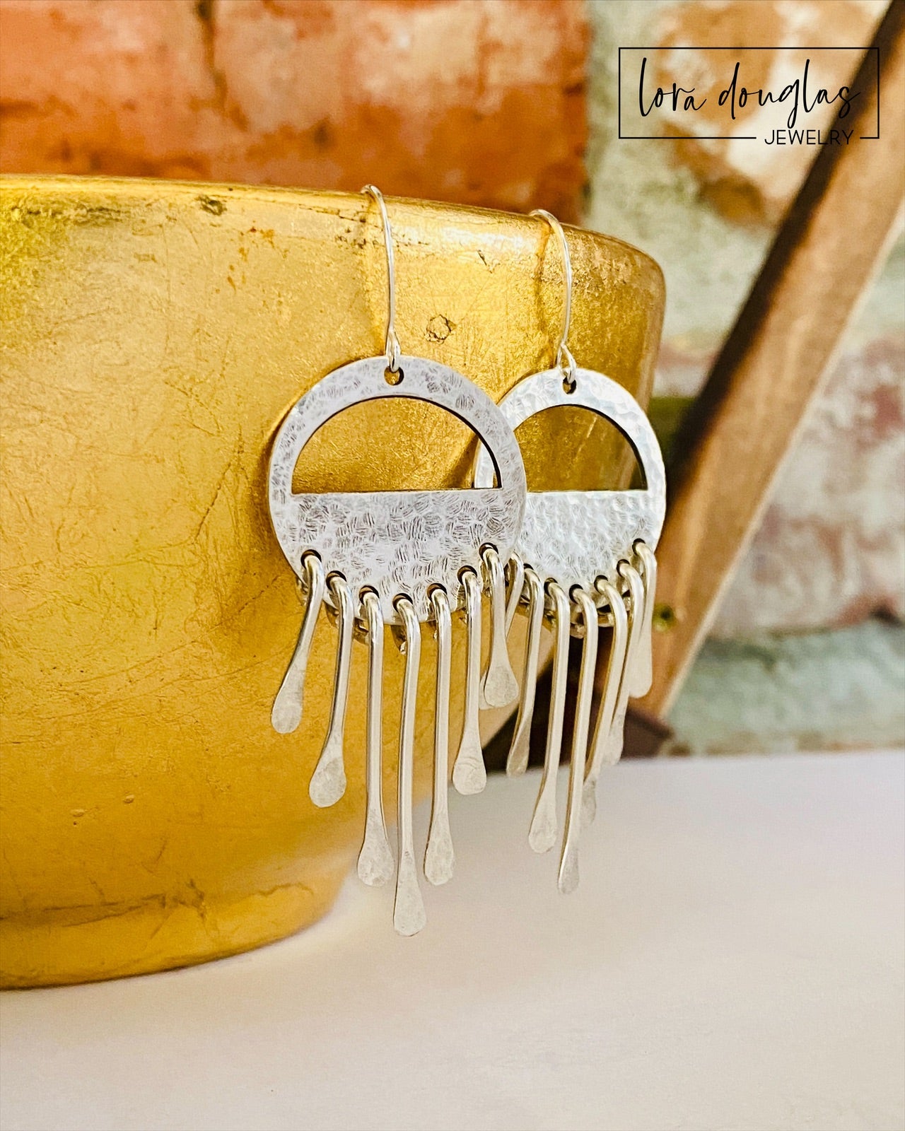 Close view of handcrafted 925 sterling silver wind chime earrings showing the individual dangling silver elements, polished metal details and sterling silver ear wires of this approximately 2.5 inch artisan design.
