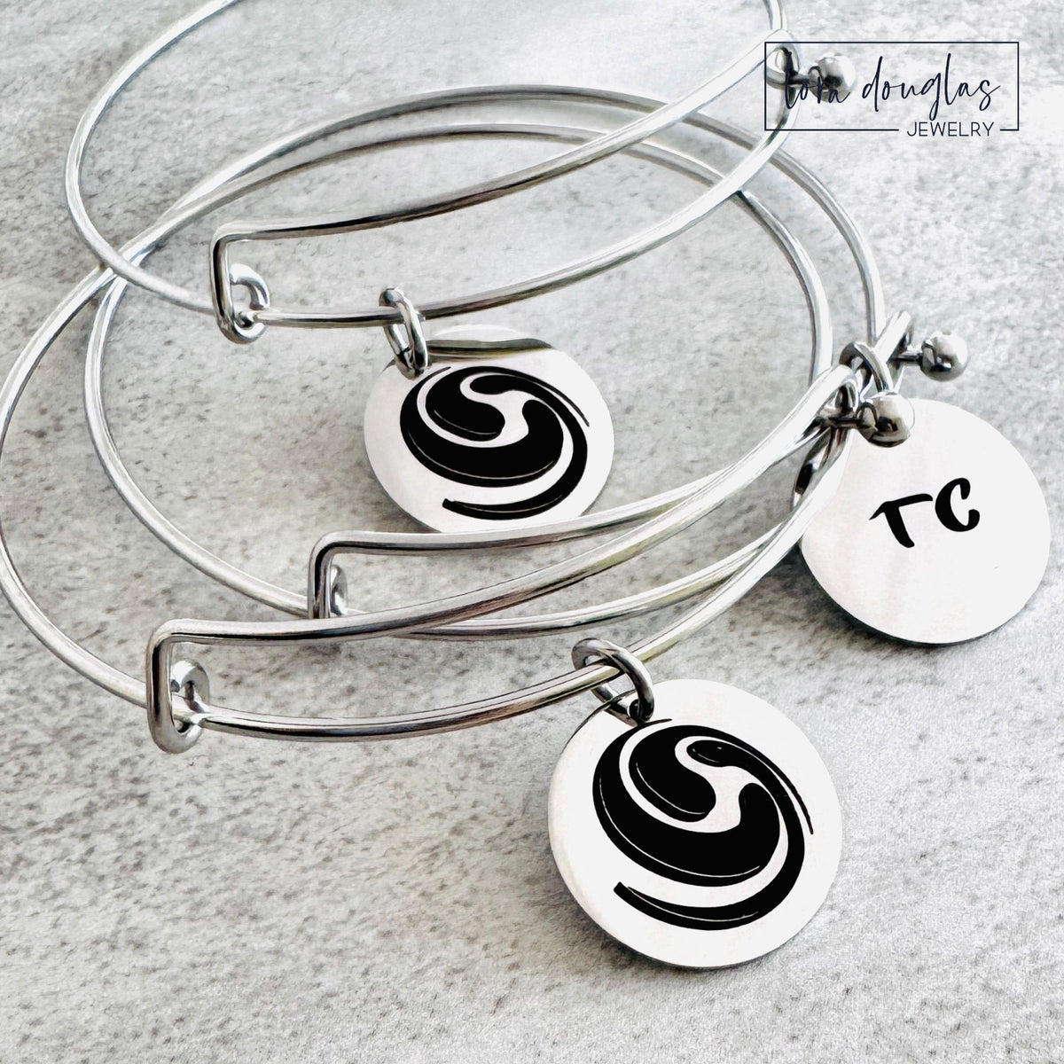 Custom art pendant displaying original artwork permanently laser engraved in black on a round stainless steel charm, with multiple pendant sizes and silver, gold, or rose gold finishes available for personalized jewelry
