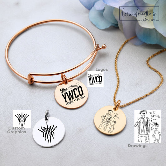 Custom artwork jewelry featuring a personal black and white design laser engraved on a round stainless steel pendant, available in silver, gold, or rose gold as a custom charm, necklace, or bangle bracelet
