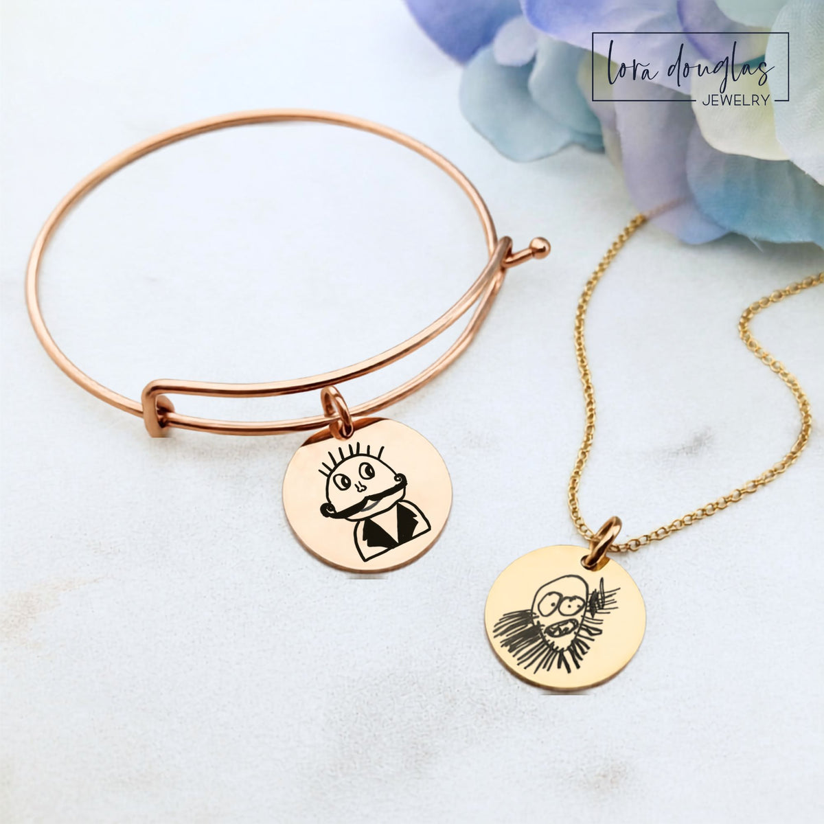 Custom child drawing bracelet with a round stainless steel pendant engraved from a kid's original artwork, creating personalized keepsake jewelry available in silver, gold, and rose gold finishes with optional back engraving.