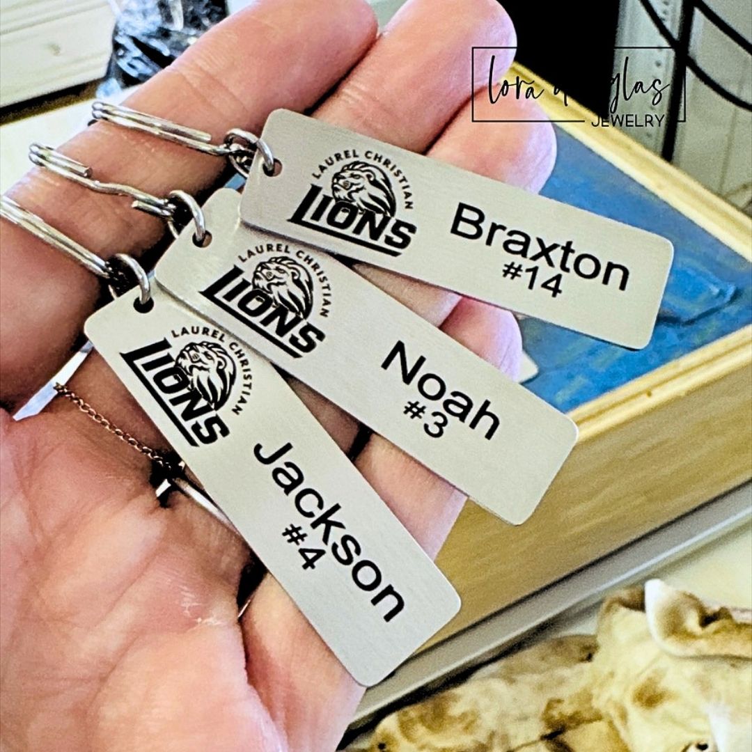 Custom engraved restroom keychain tag featuring a business logo on a durable silver stainless steel bar with standard key ring, ideal for customer bathroom keys in restaurants, boutiques, offices, salons, studios, and retail businesses