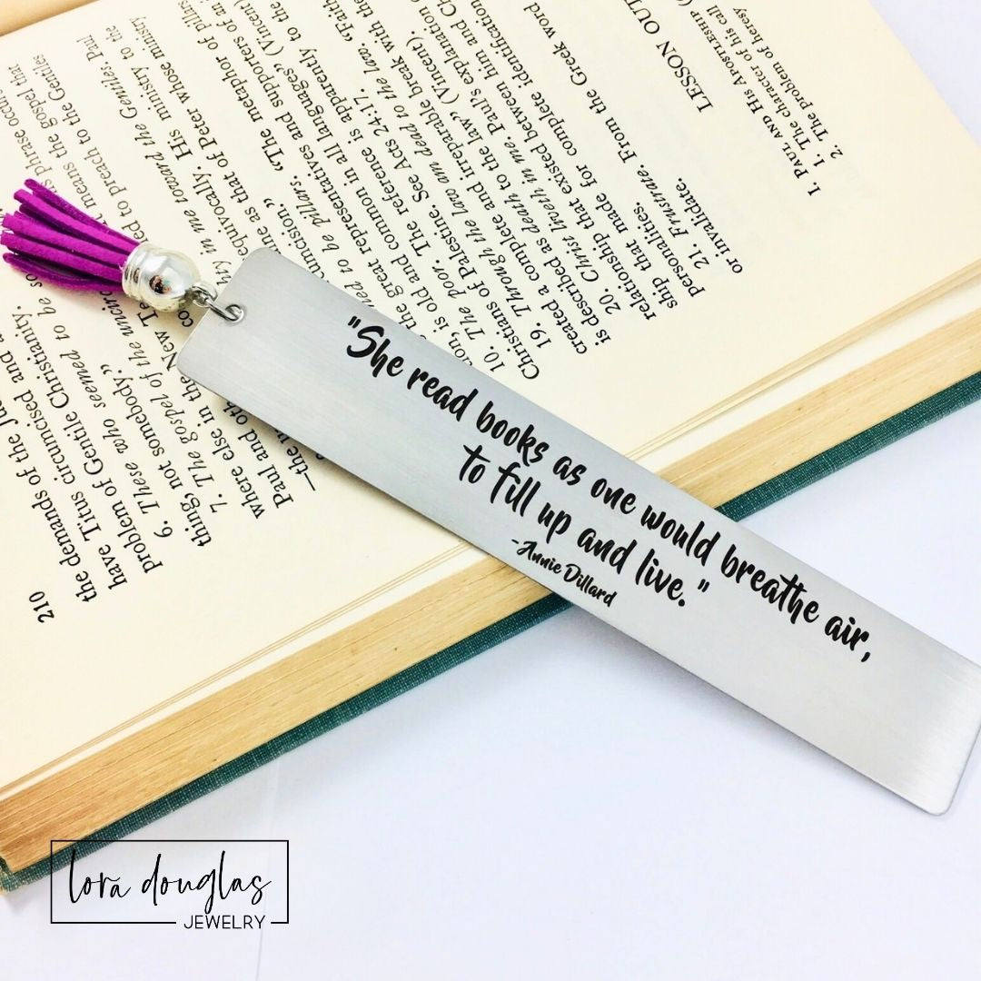 Elegant engraved bookmark featuring the quote "She read books as one would breathe air to fill up and live" on brushed stainless steel. Personalized reader gift for book lovers, librarians, BookTok fans, authors, and literature enthusiasts.