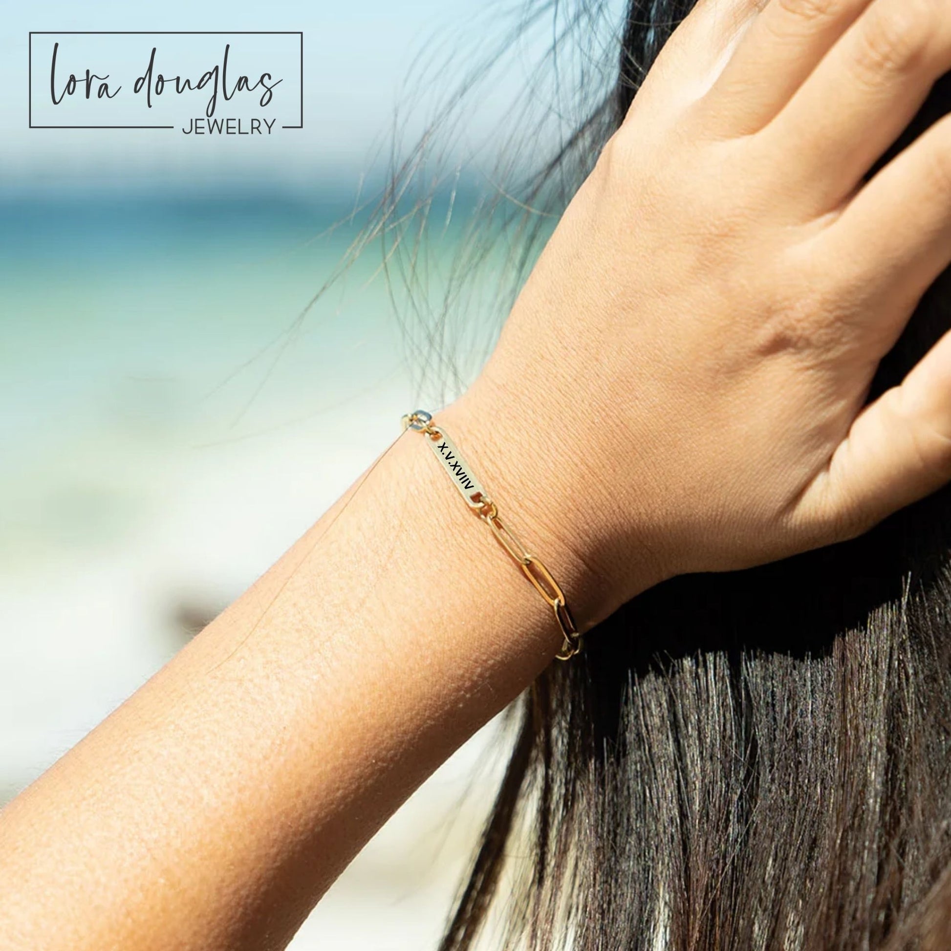 Gold bracelet on a wrist with a blurred background
