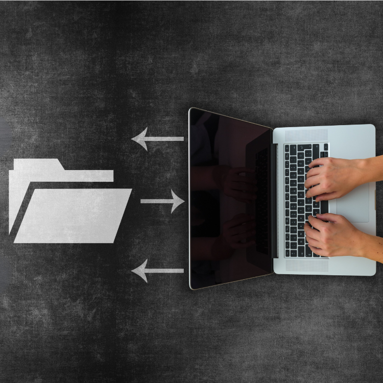 Person using a laptop with a stylized folder icon and arrows on a dark surface