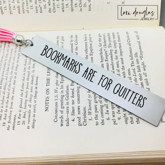 Funny stainless steel bookmark engraved with the phrase "Bookmarks Are for Quitters" and finished with a colorful tassel. Humorous gift for book lovers, BookTok readers, authors, librarians, book clubs, and avid readers who can't stop reading.