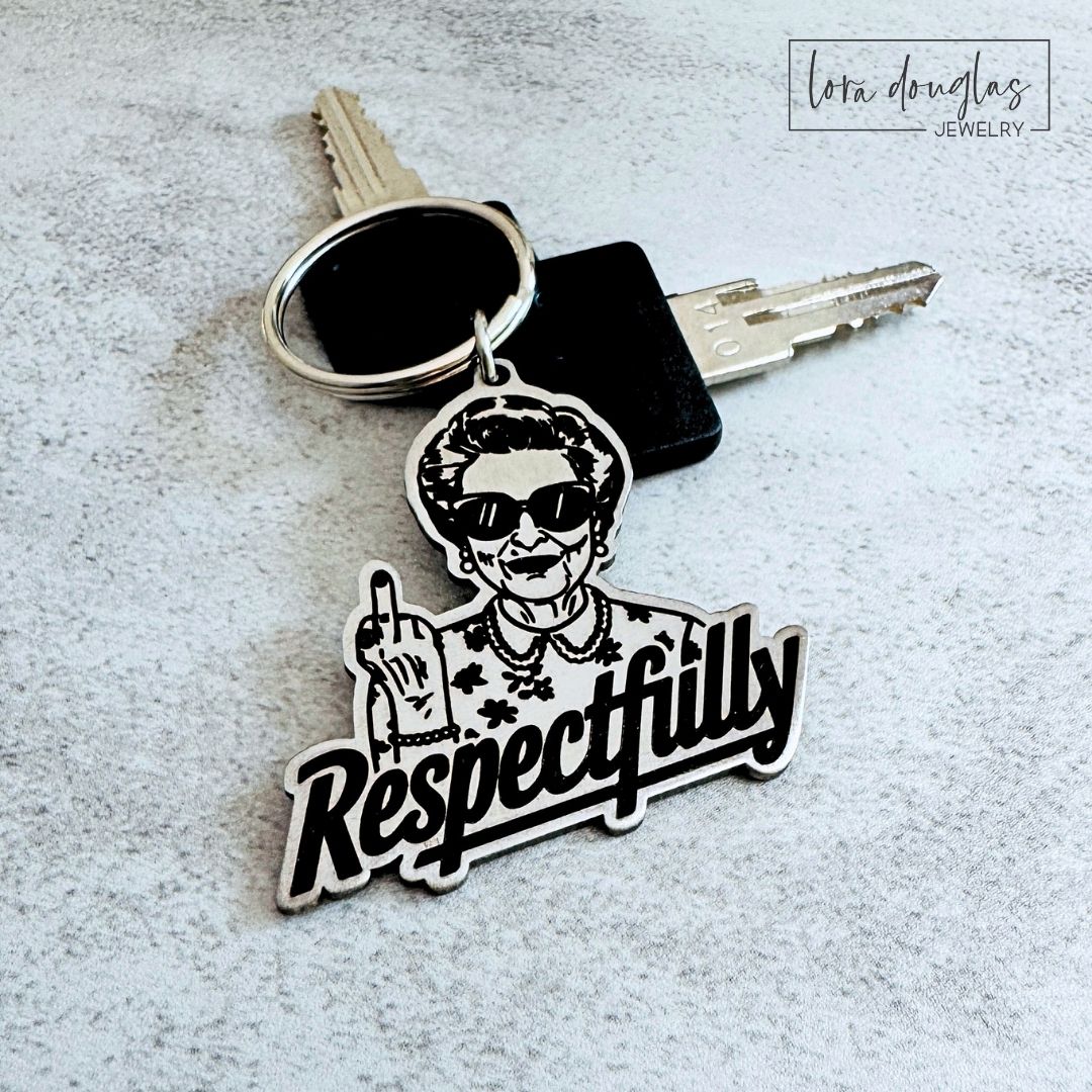 Funny stainless steel keychain featuring an irreverent woman giving the middle finger above the word Respectfully, with measurements showing the approximately 1.5 inch wide and tall engraved keychain or bag tag.