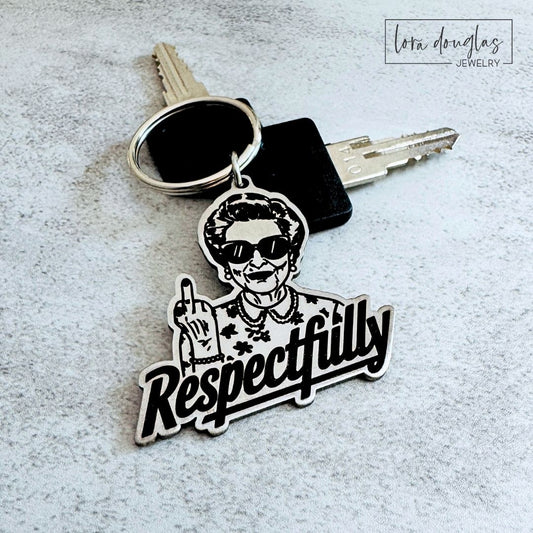 Funny stainless steel keychain featuring an irreverent woman giving the middle finger above the word Respectfully, with measurements showing the approximately 1.5 inch wide and tall engraved keychain or bag tag.