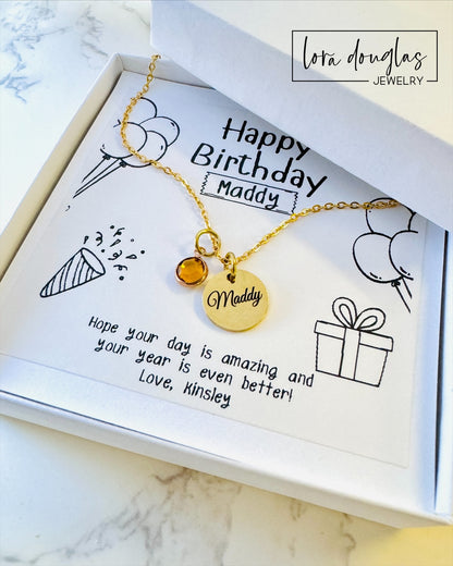 A personalized gold stainless steel necklace with a name and birthstone charm, presented in a box with a personalized birthday message.