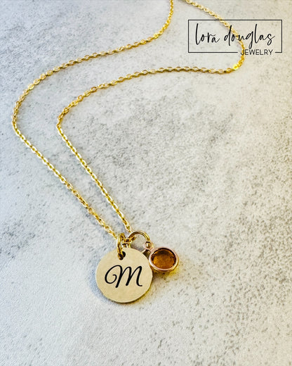 Gold necklace with birthstone charm engraved with a name or custom text