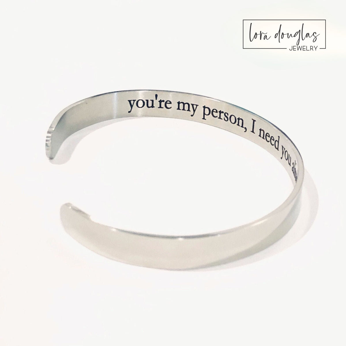 Gold stainless steel personalized cuff bracelet with a secret message laser engraved on the inside, creating a private piece of custom jewelry for a partner, spouse, girlfriend, boyfriend, daughter or friend.