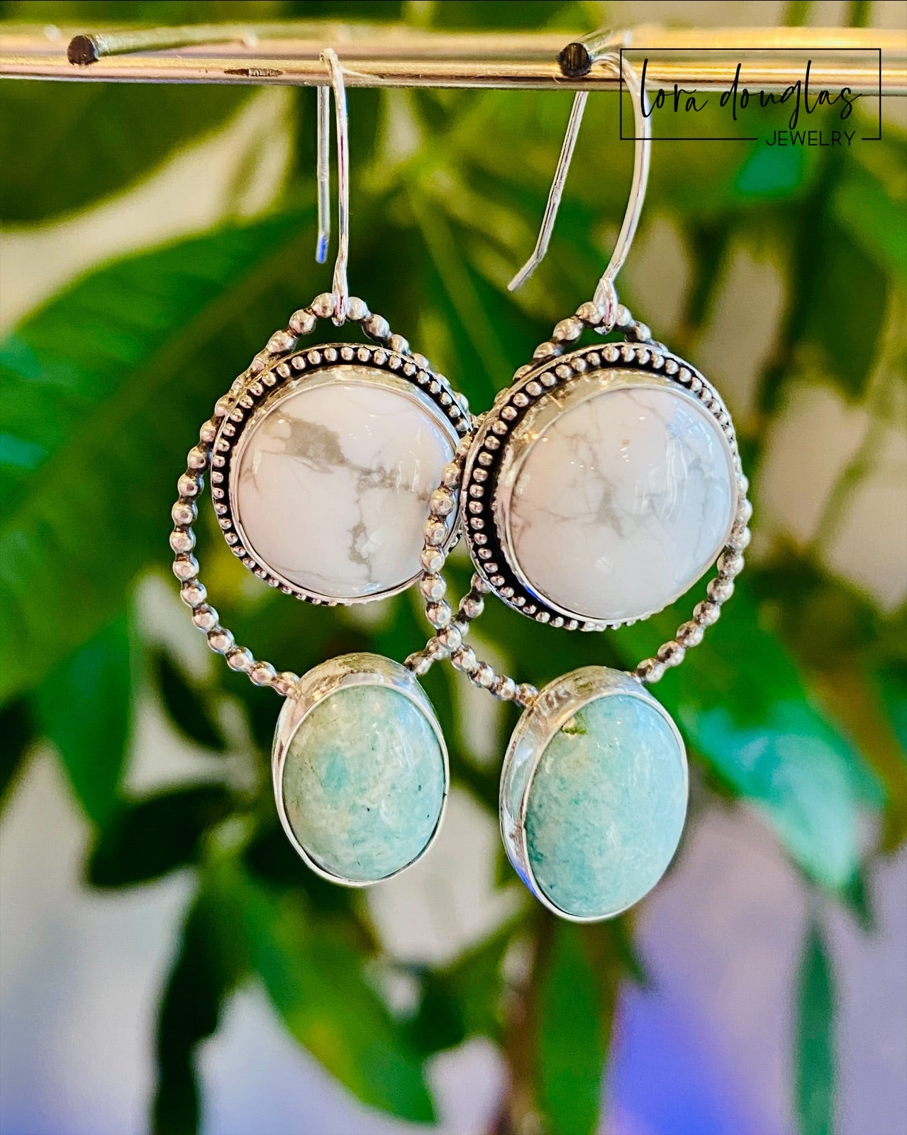 Howlite and amazonite earrings featuring two oval natural gemstones connected in a long sterling silver dangle design, with contrasting white and pale green colors for shoppers who love unique stone jewelry.

