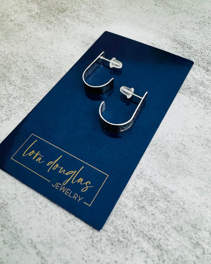 Pair of hoop earrings on a navy card with 'Lora Douglas Jewelry' branding.