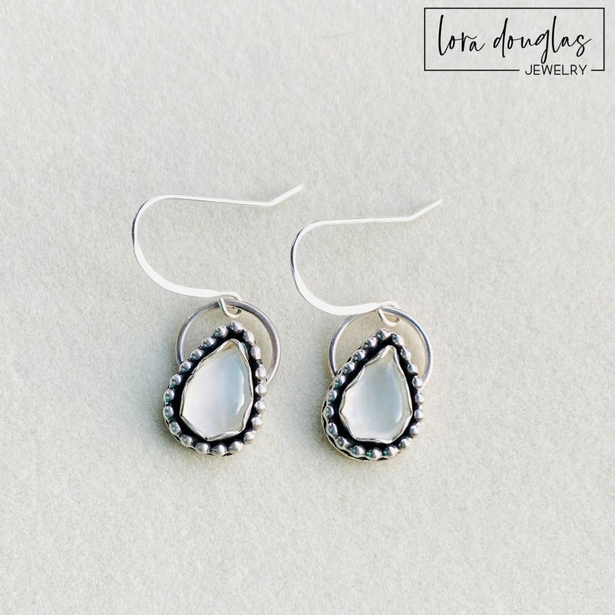 Moonstone sterling silver earrings featuring natural gemstones with soft luminous coloring, paired with classic silver for an understated gemstone jewelry design and a meaningful June birthstone gift.
