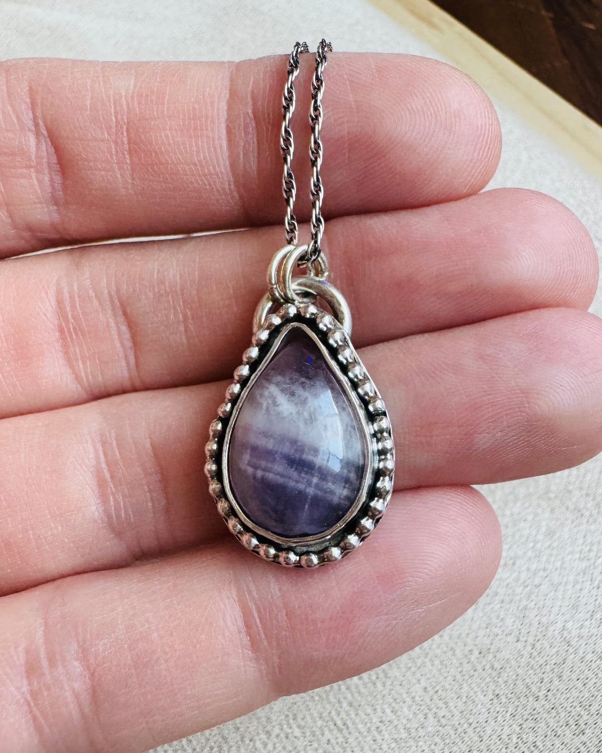 Natural amethyst necklace featuring a banded purple gemstone pendant measuring approximately 17mm x 27mm, complemented by 925 sterling silver for a classic gemstone necklace with individual stone character.
