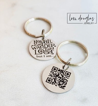 Two keychains with engraved text on a light background, featuring the brand 'Lora Douglas Jewelry'.