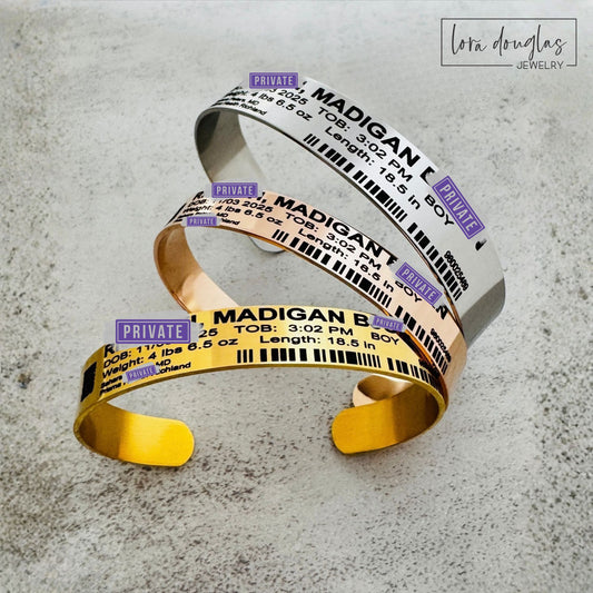 Personalized baby hospital ID bracelet keepsake engraved with newborn birth details, including the baby's name, date of birth, hospital and patient information on a stainless steel cuff designed like a hospital band.
