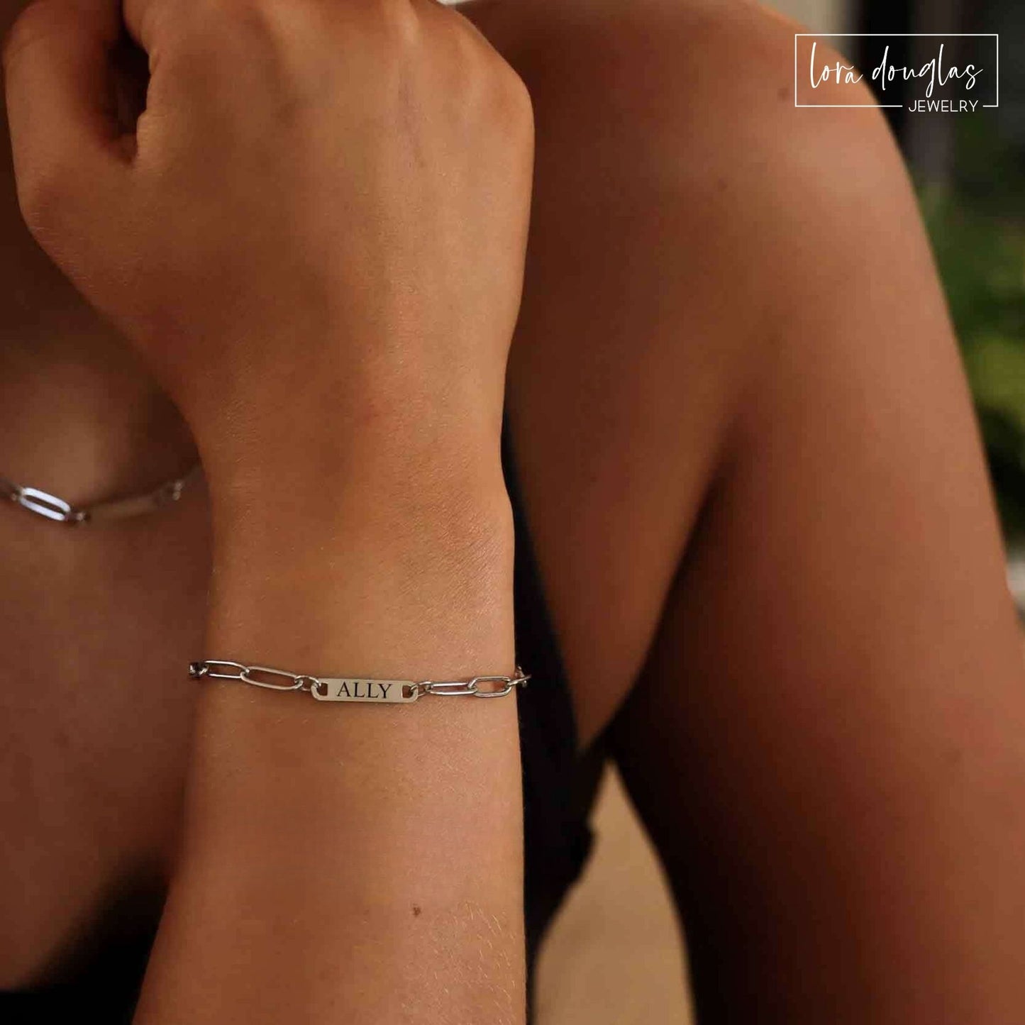 Personalized silver paperclip bar bracelet worn on wrist