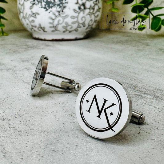 Silver Cufflinks engraved with a logo on a textured surface, with 'lora Douglas' branding.