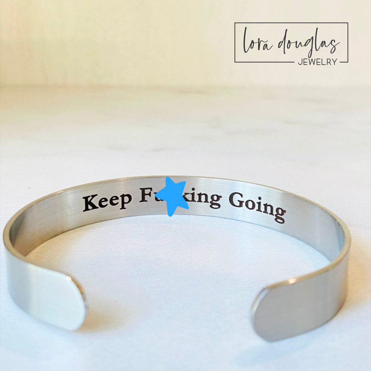 Silver stainless steel hidden message cuff bracelet with personalized inside engraving and a simple blank exterior, a meaningful custom jewelry gift for an anniversary, graduation, birthday or special occasion.