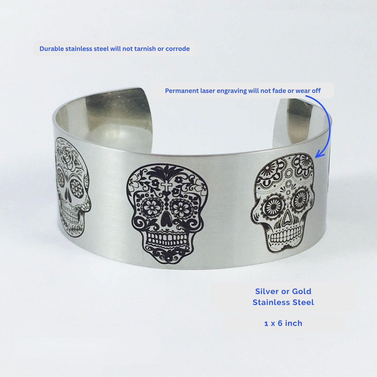 Silver stainless steel sugar skull bracelet with detailed engraved skull artwork wrapping around the wide cuff, featuring a matte finish and 1 inch width for women who love skull jewelry and alternative accessories.
