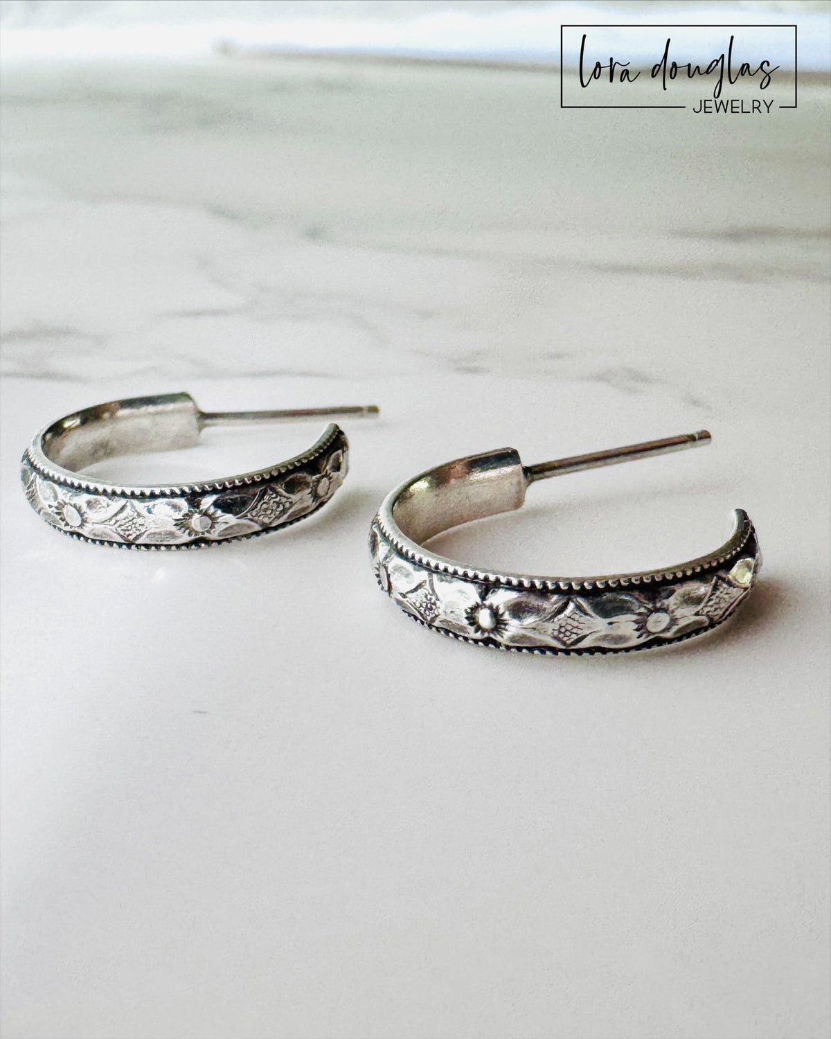 Small 925 sterling silver post hoop earrings with a compact 1/2 inch diameter, offering a simple polished silver look for shoppers seeking petite hoops that pair easily with everyday jewelry.
