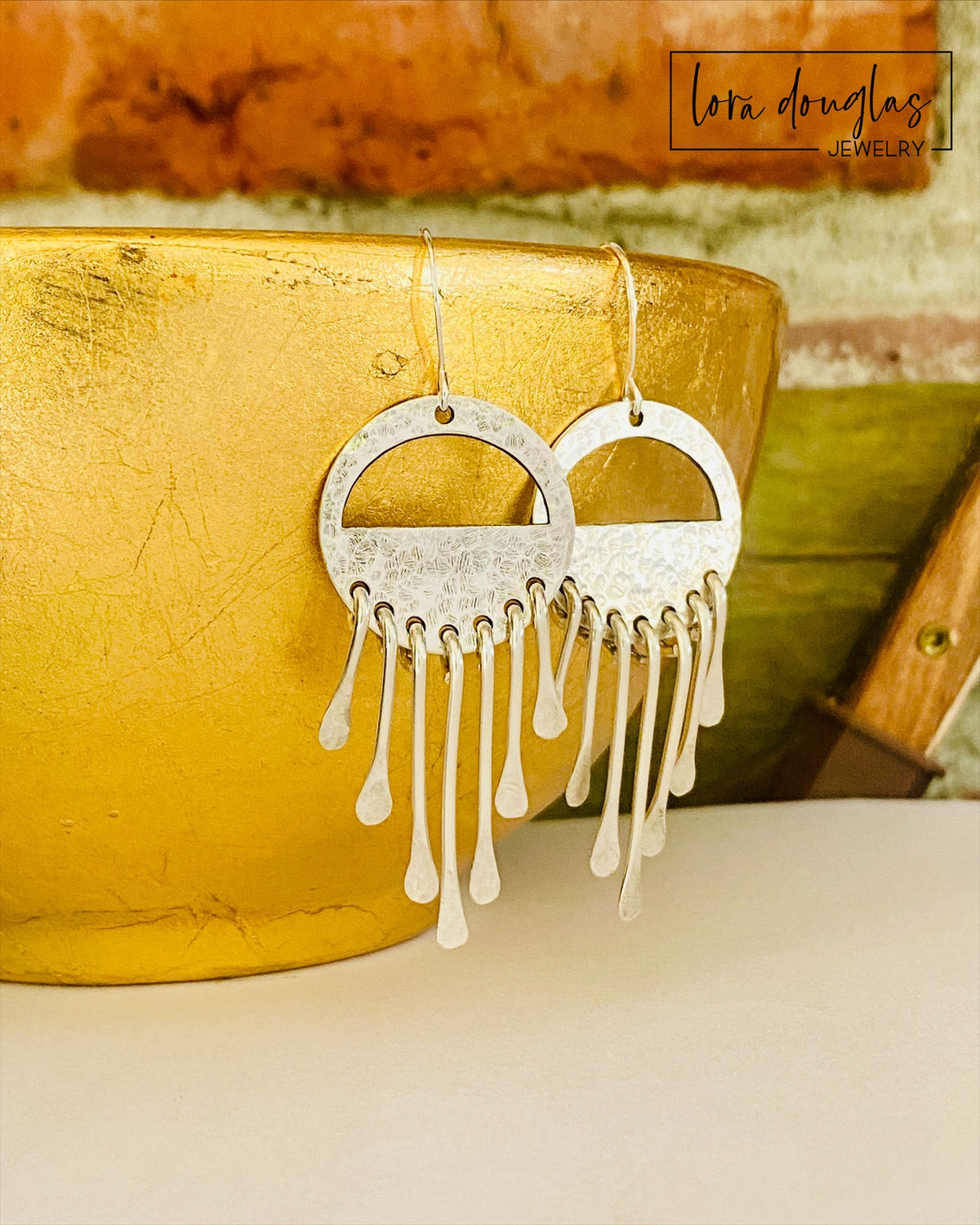 Sterling silver fringe earrings featuring multiple moving silver elements in a distinctive wind chime inspired design, creating lightweight long dangle earrings for shoppers seeking unique handcrafted silver jewelry.
