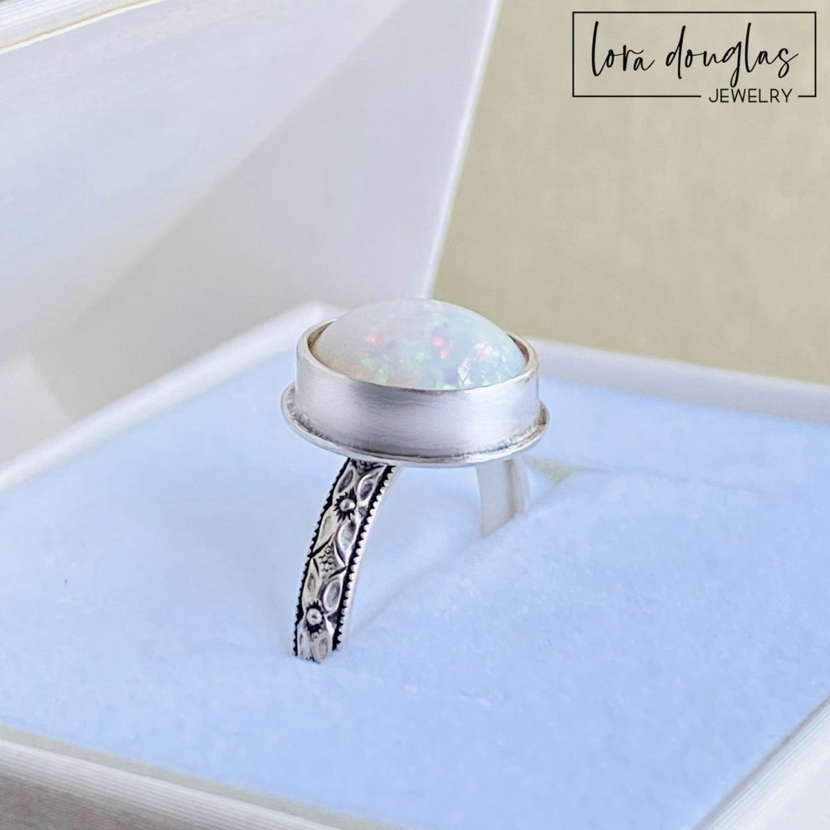 Sterling silver opal ring featuring a hand cut 10mm x 12mm cabochon in an oval bezel setting, handcrafted in finished US size 7.75 for lovers of natural opal jewelry and artisan silver rings.
