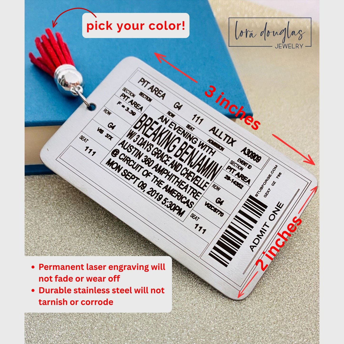 custom concert ticket bookmark displayed beside books and music memorabilia, engraved stainless steel bookmark designed to look like a real concert ticket with personalized event details