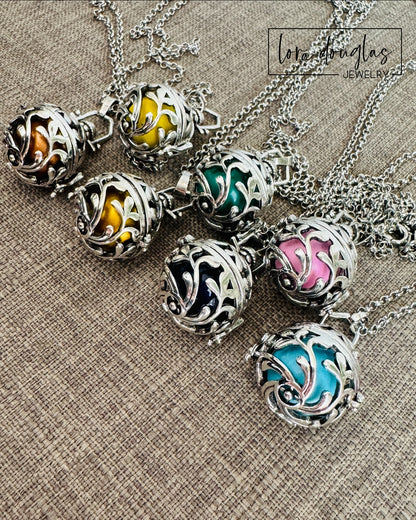 An Angel Caller, also referred to as a “Bola” or “Harmony Ball," is an ancestral jewelry that has been celebrated for centuries in different cultures. The pendant contains a metal ball that emits a subtle and harmonious chime when shaken, that brings calm and soothing. Legend has it that the soft jingling sound, that is unique for each Bola has the power to call the Guardian Angel of the wearer to provide them protection and comfort.