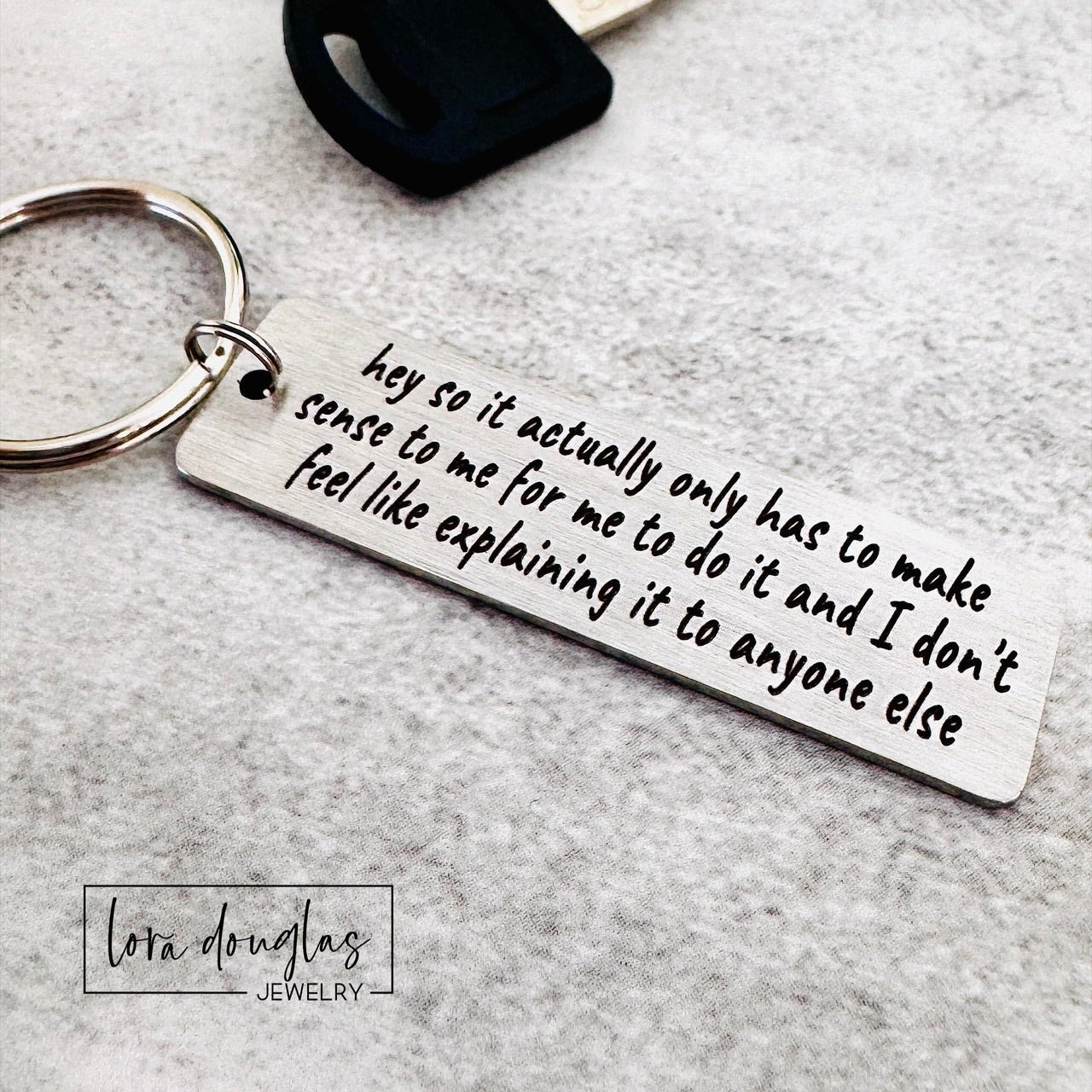  stainless steel keychain features the iconic "365 buttons" TikTok quote laser-engraved in full: "hey so it actually only has to make sense to me for me to do it and I don't feel like explaining it to anyone else." A must-have for independent spirits who live by their own rules and couldn't care less about justifying themselves. 
