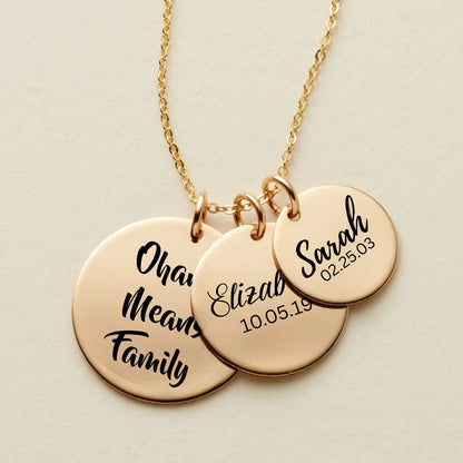 rose Gold necklace with three round pendants engraved with names and dates on a beige background
