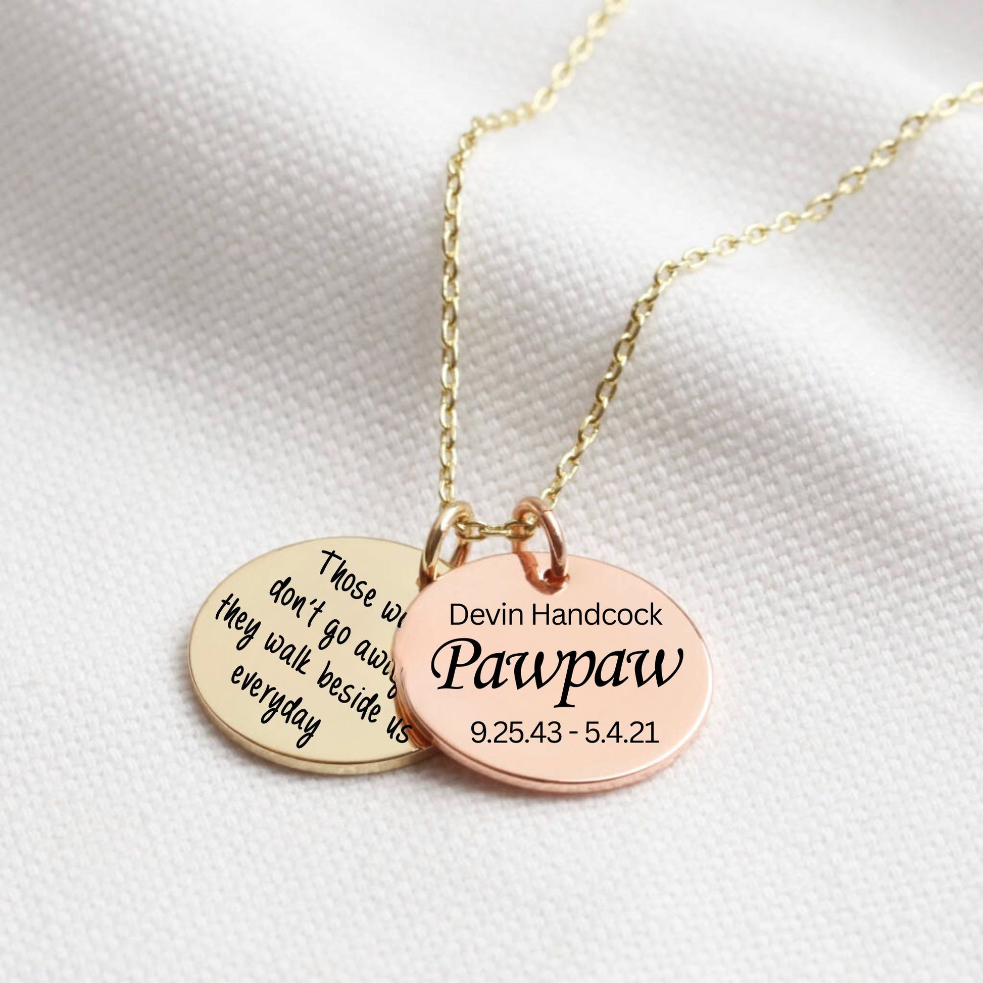 Gold and Rose Gold necklace with two engraved discs on a white background